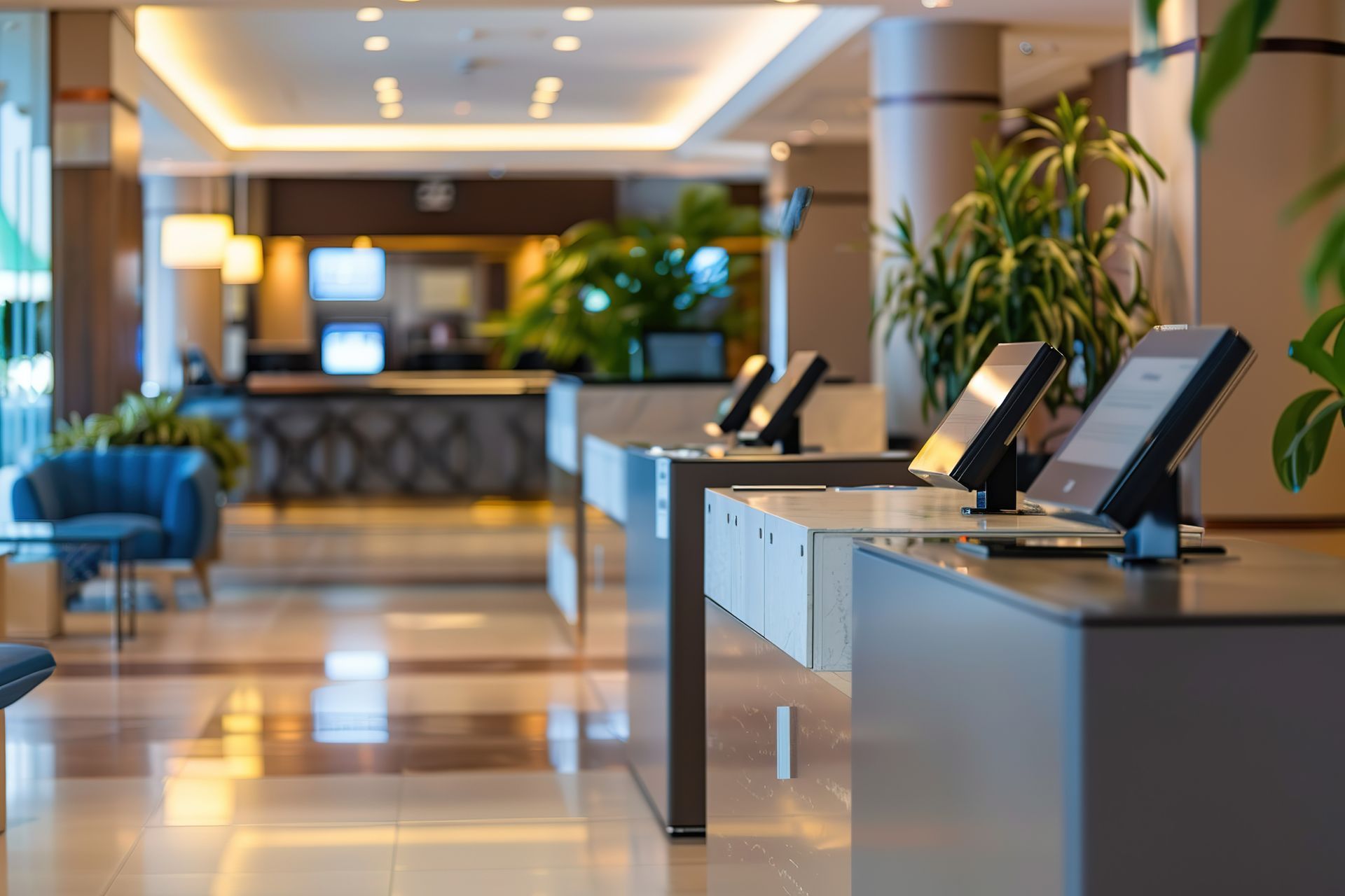 A hotel lobby with a row of desks and monitors