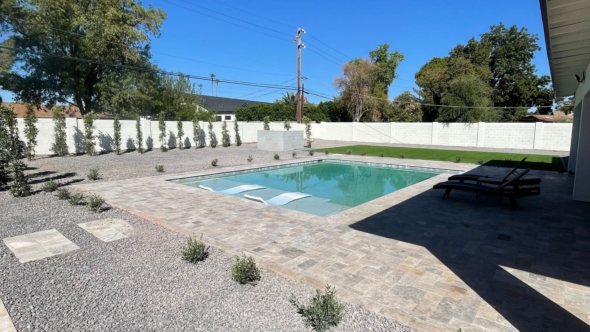 A large swimming pool in the backyard of a house