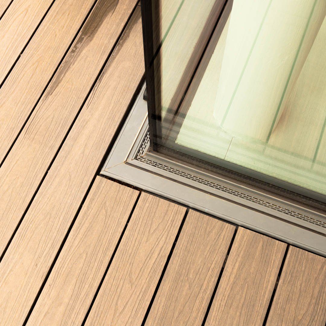 Close up of a wooden deck  and threshold drain