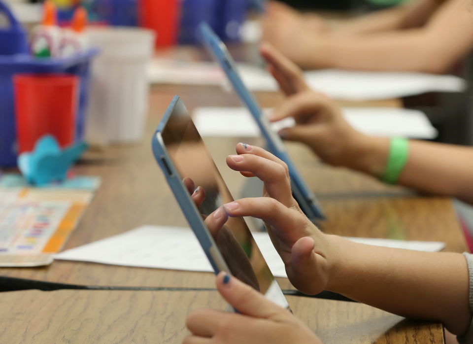 Kids using tablets in a classroom