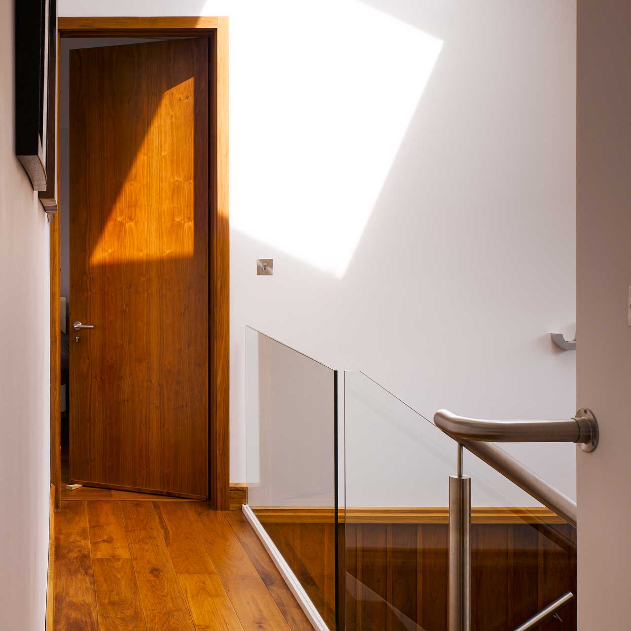 Upstair hallway with a wooden floor designed by Dublin Design Studio