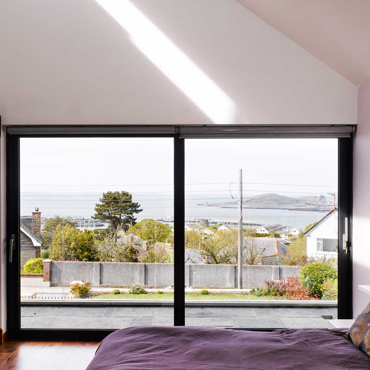 Galtee Lodge's bedroom with large glass doors designed by Dublin Design Studio