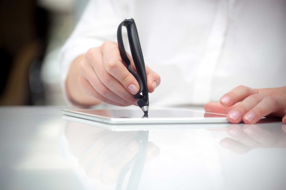 A person using the Scriba stylus on a tablet