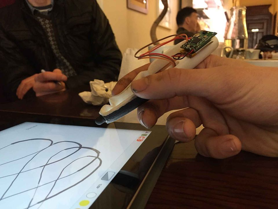 A person holding a Scriba stylus in its early stage of development.