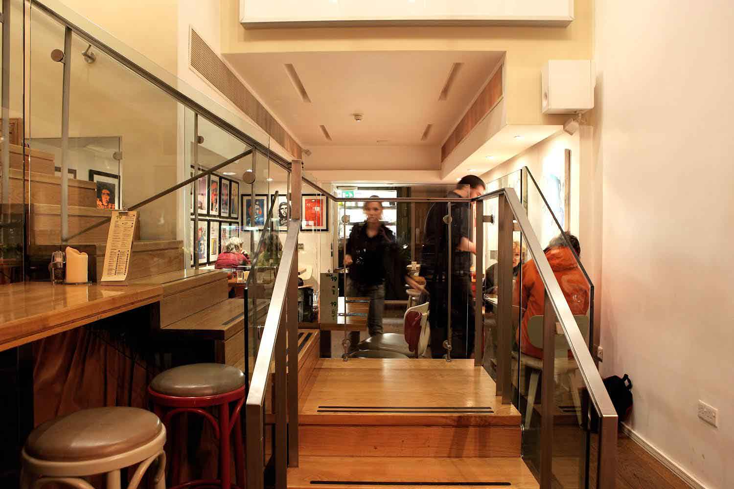 Inside view of the Green 19 restaurant's stairs and dinning room designed by Dublin Design Studio