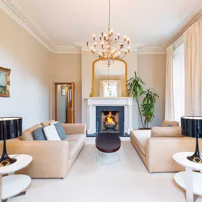 A photo of the living room at 'Fitzwilliam Tennis Club, Dublin' the interior with a fireplace of a Suite at the Fitzwilliam Tennis Club designed by 'Dublin Design Studio'