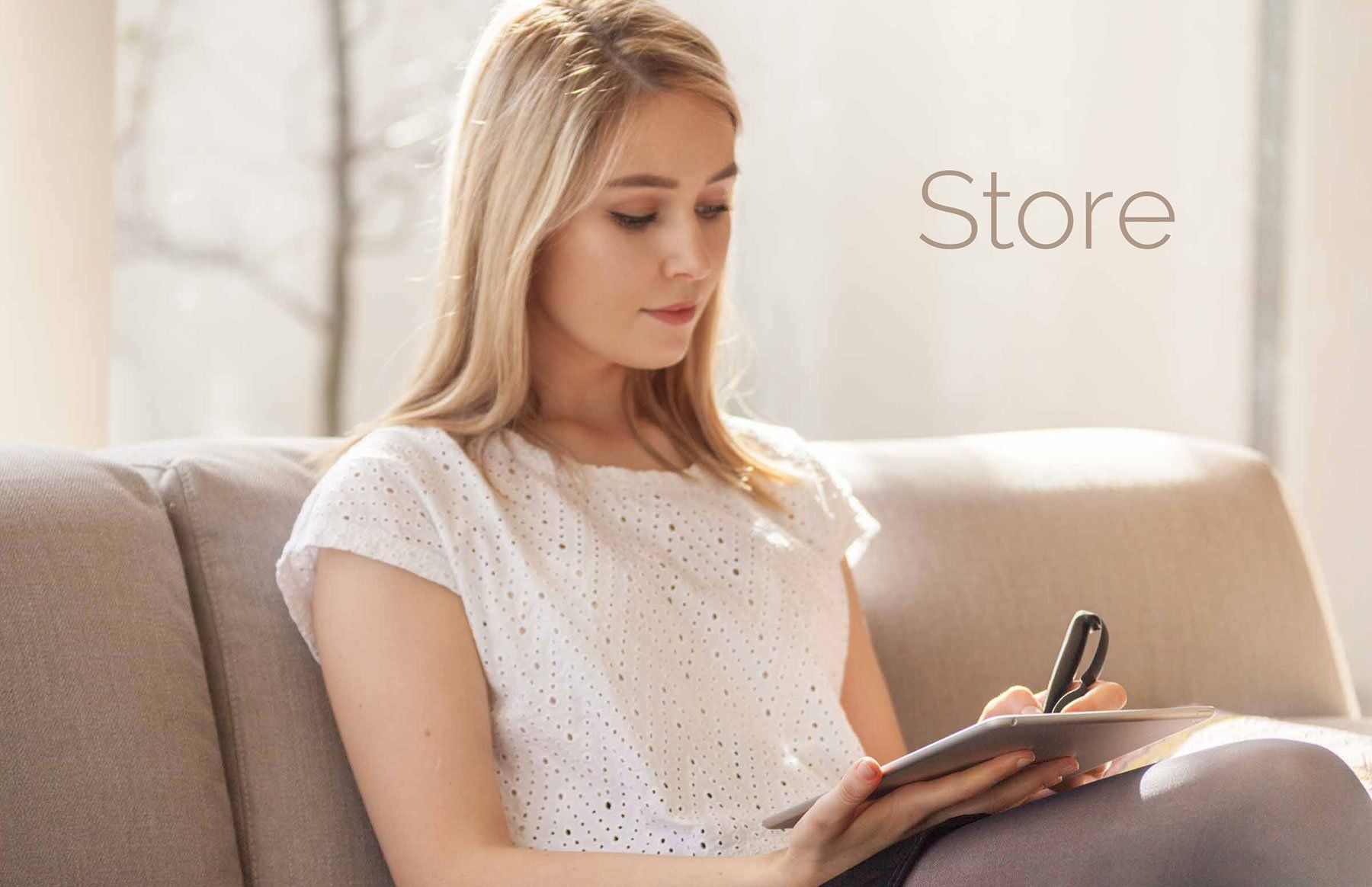 Comfortable living room with a women using the 'Scriba Stylus' on an iPad