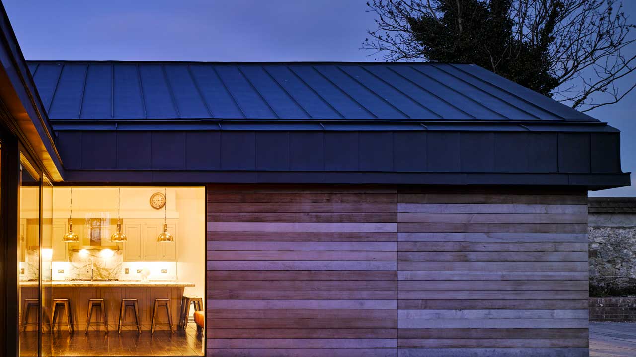 Timber cladding at a remodelled and extended protected structure.