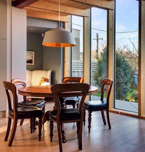 Dalkey house's dining room showcases elegant furnishings and ample natural light, creating a warm, inviting ambiance.
