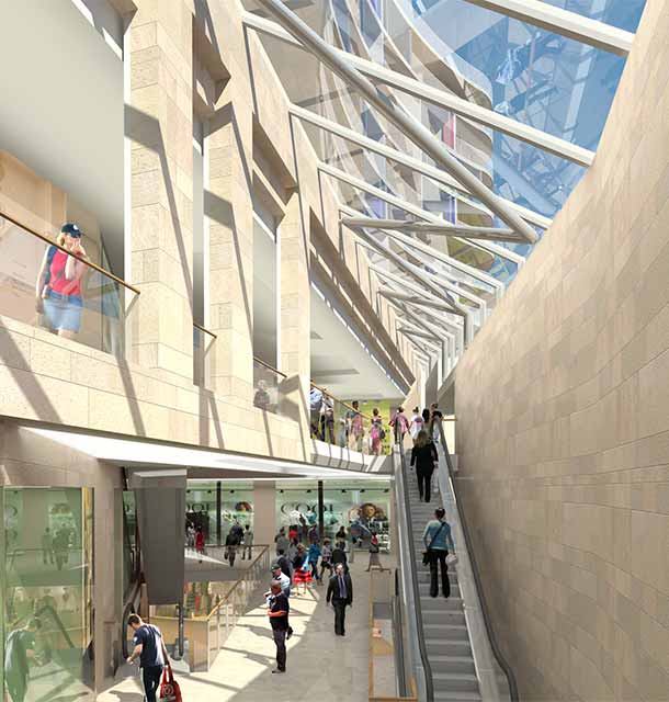 A group of people are walking down stairs in a modern shopping centre