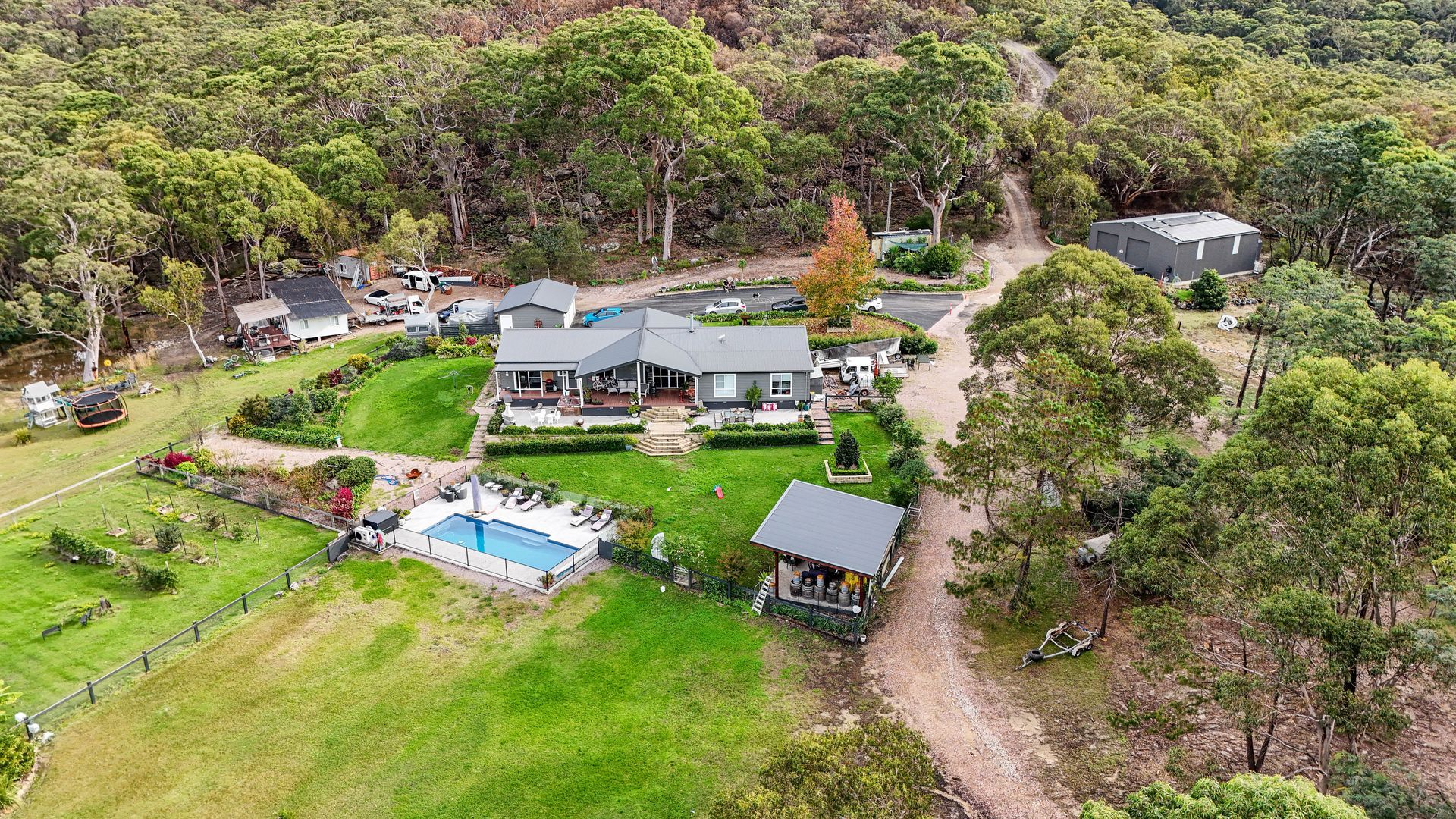 Aerial View Of A House With A Pool, Lawn Surrounded By Trees — Craig Stevens Photography in Sydney, NSW