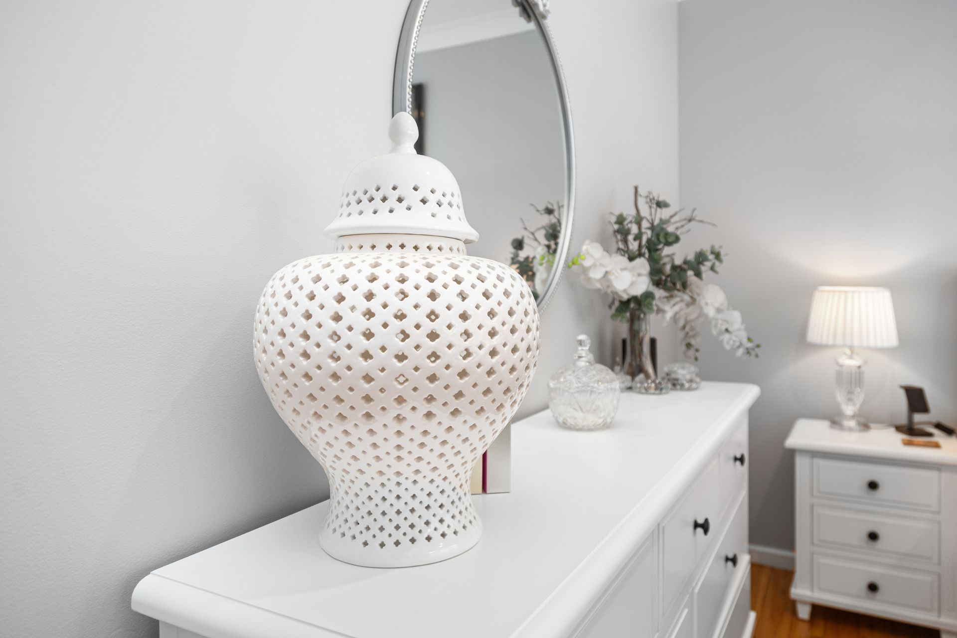 White Perforated Table Lamp On A White Dresser In A Bright Bedroom — Craig Stevens Photography in Pearl Beach, NSW