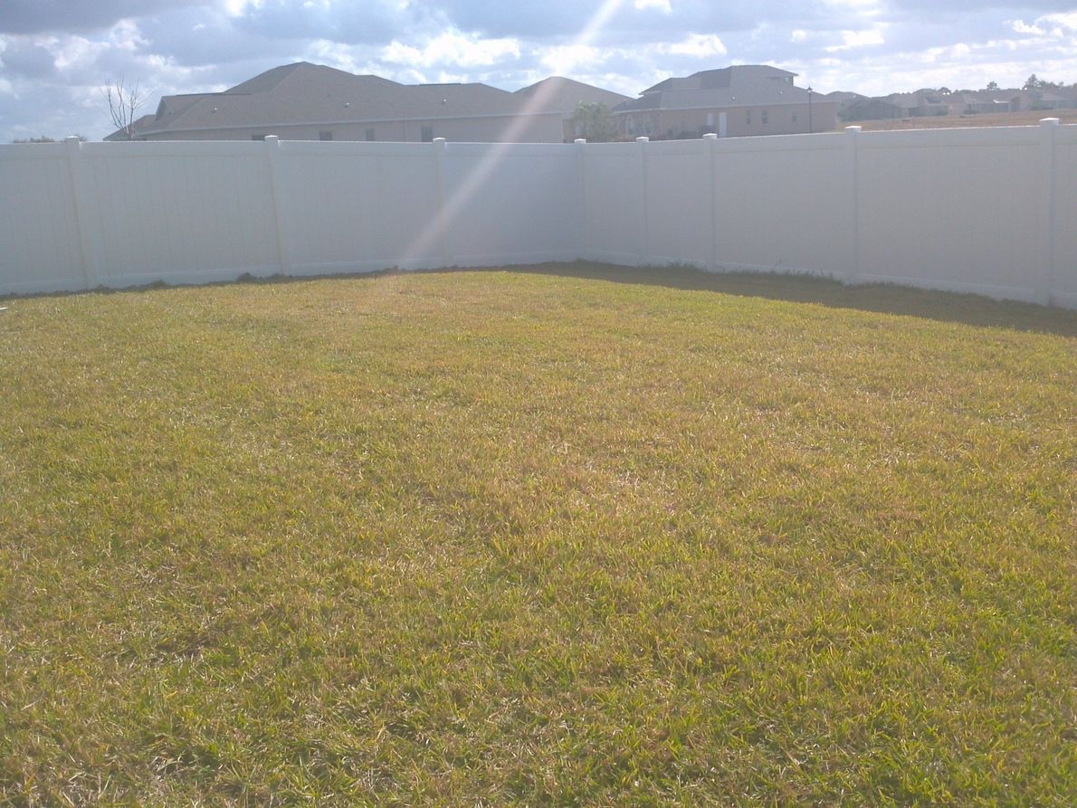 white fence residential backyardFencing Services in New Port Richey, Florida