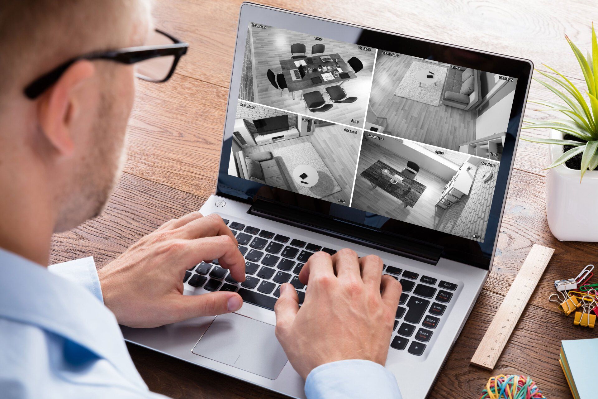 Man checking security camera footages of an office