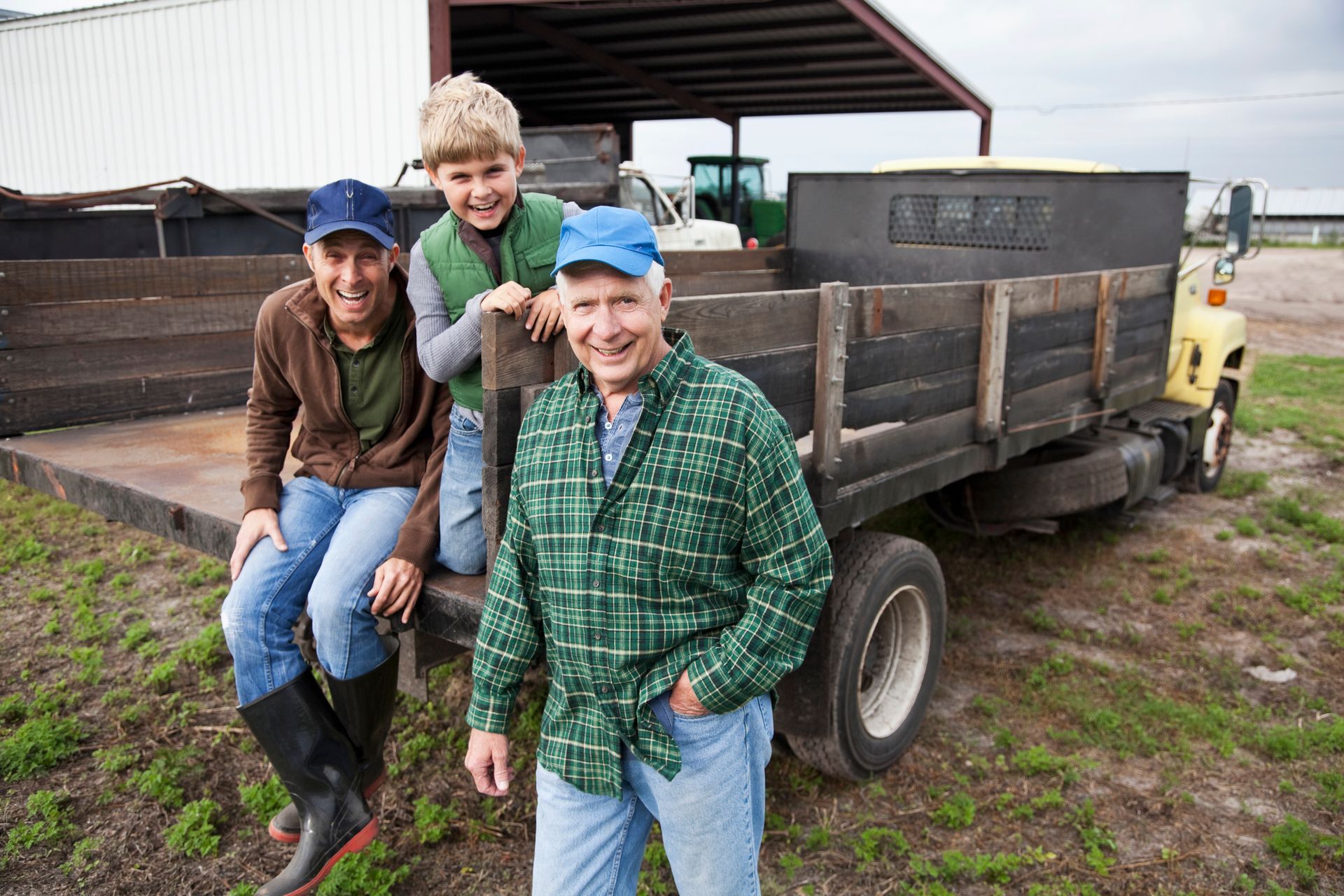 Farmers smiling in a field showcasing reliable agricultural equipment service support.
