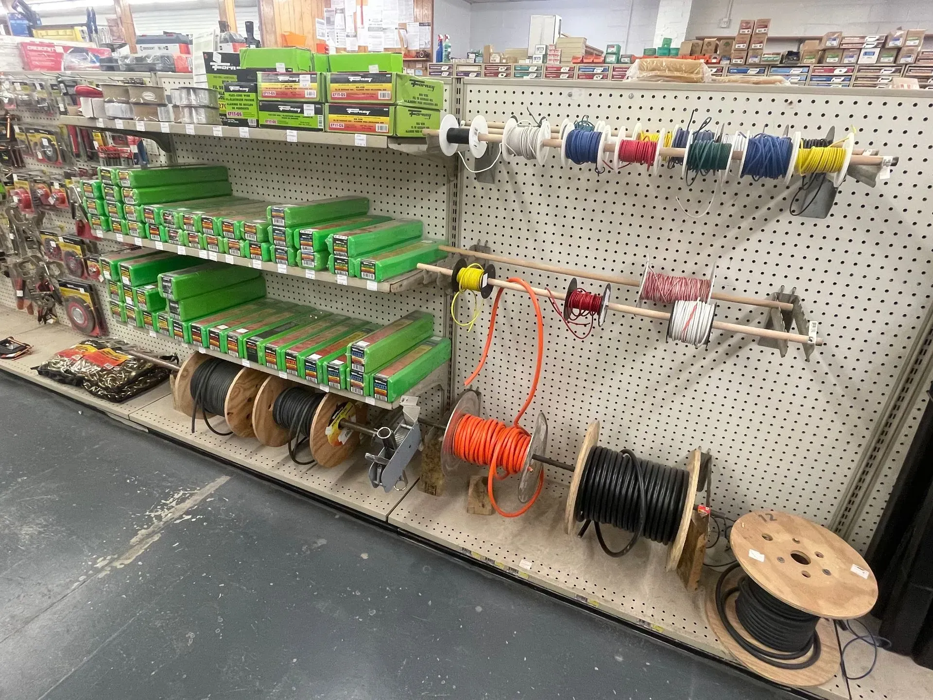 A store shelf filled with lots of electrical equipment
