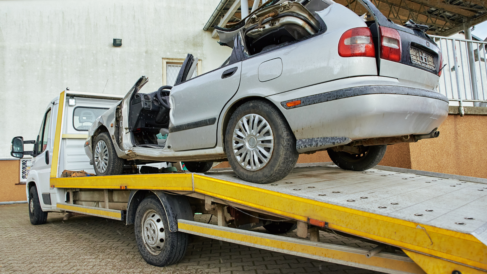 A car is being towed by a tow truck.
