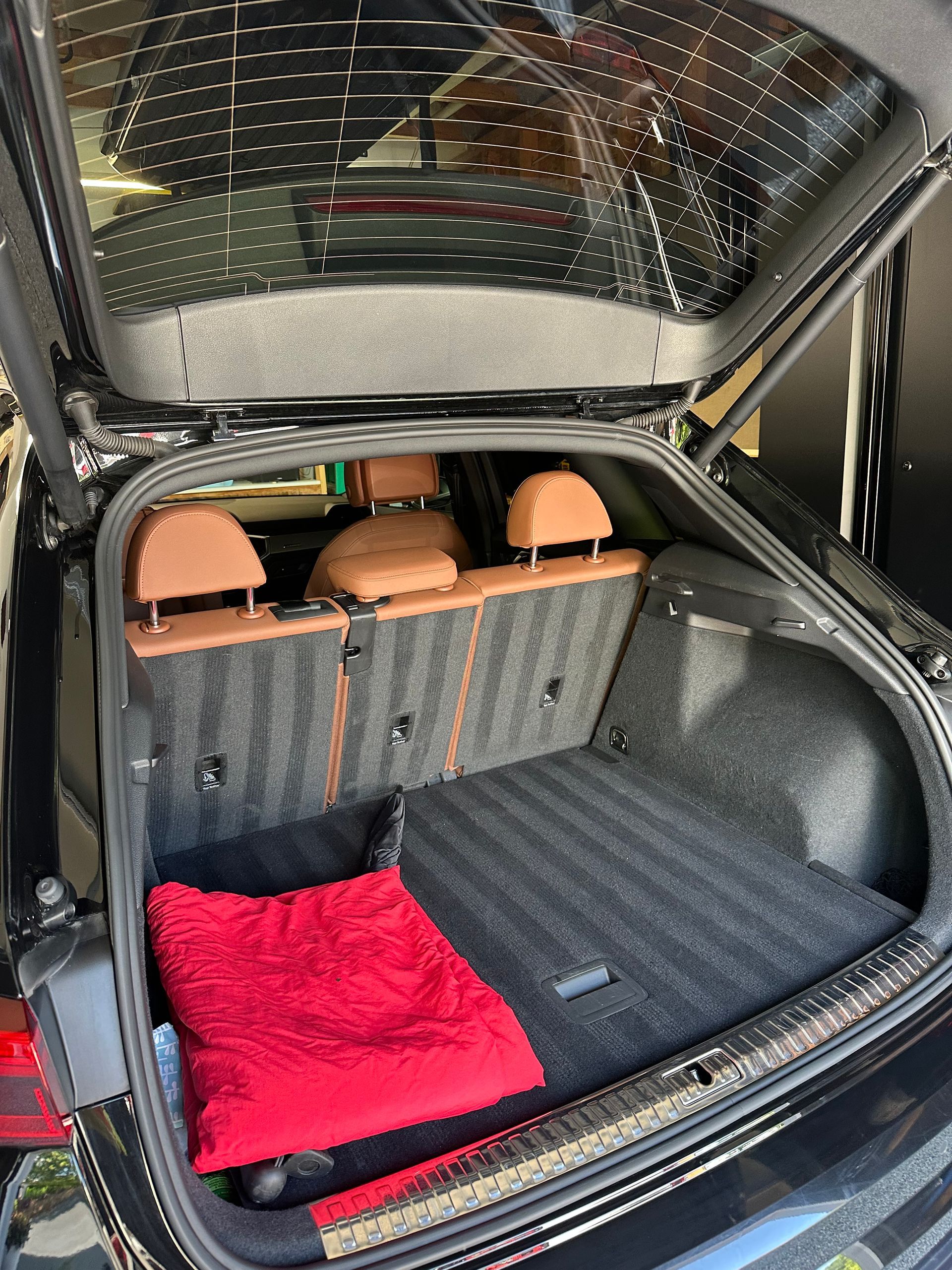 Back seat of a car with two child booster seats, one gray and one black