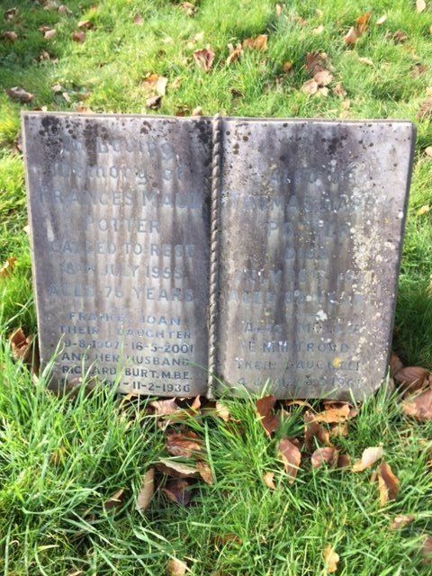 Cremation Memorial in shape of a book with unreadable writing, before renovation