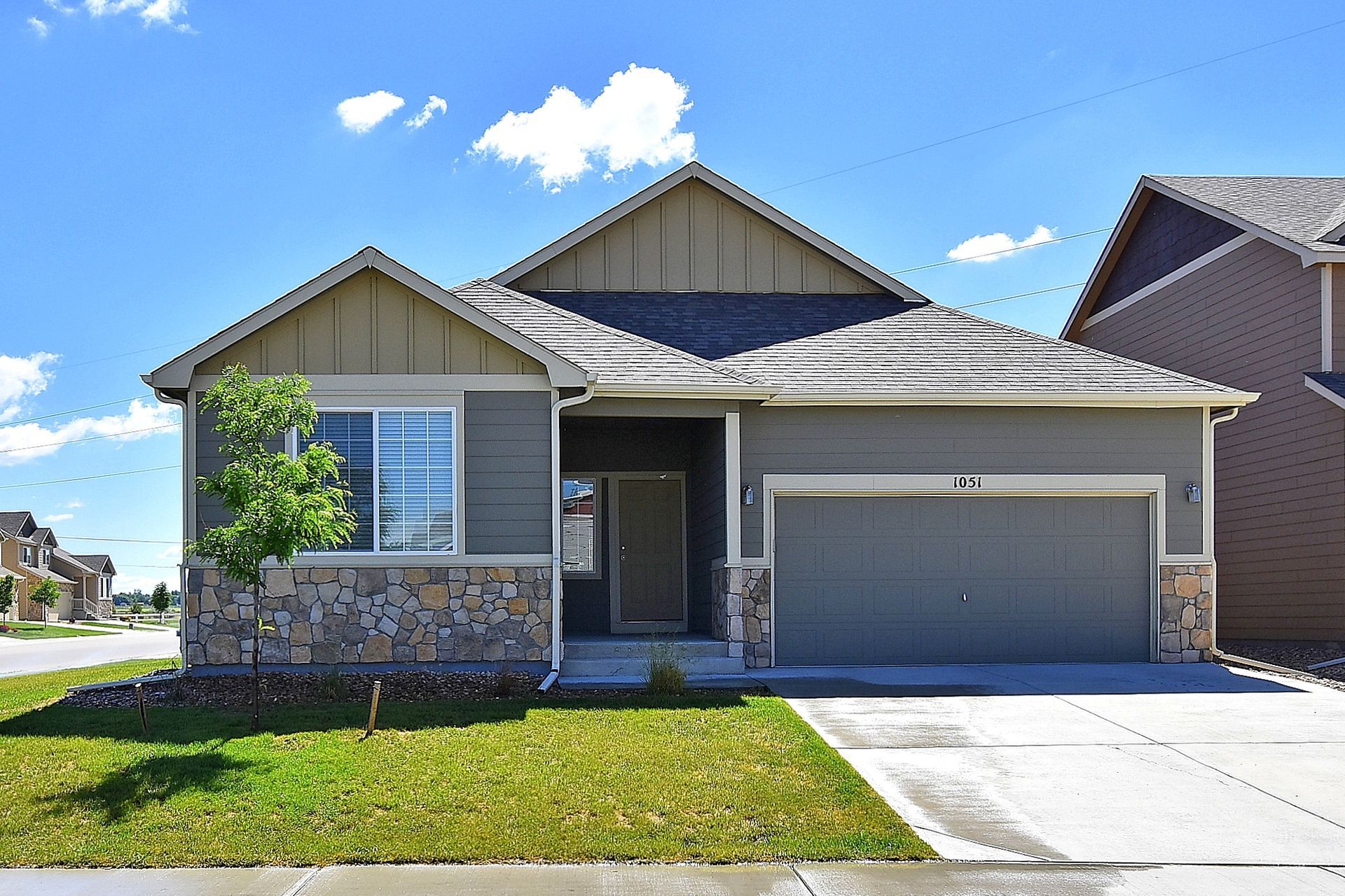 A house with a garage and a driveway in a residential area