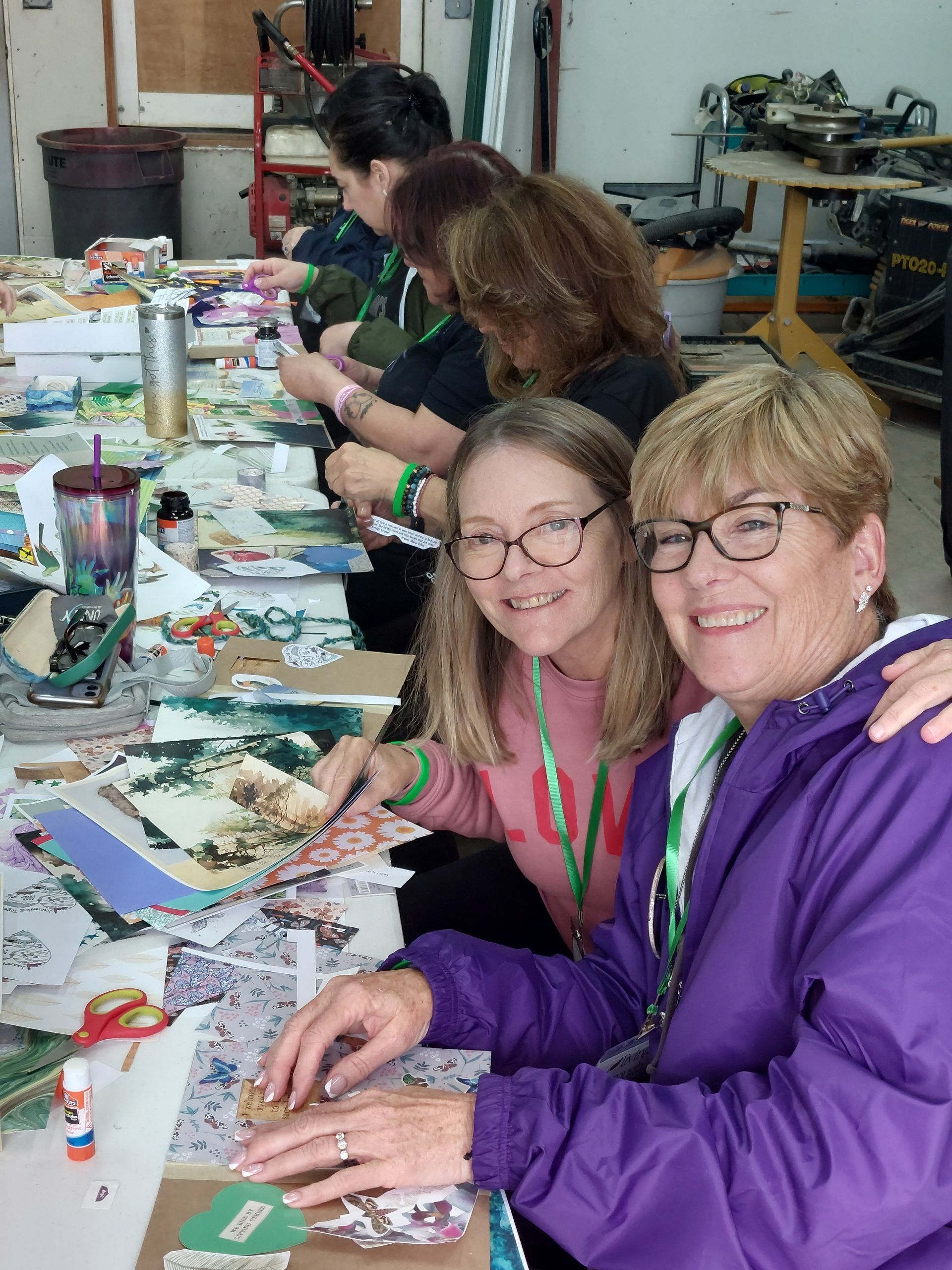 A woman in a purple jacket is hugging another woman