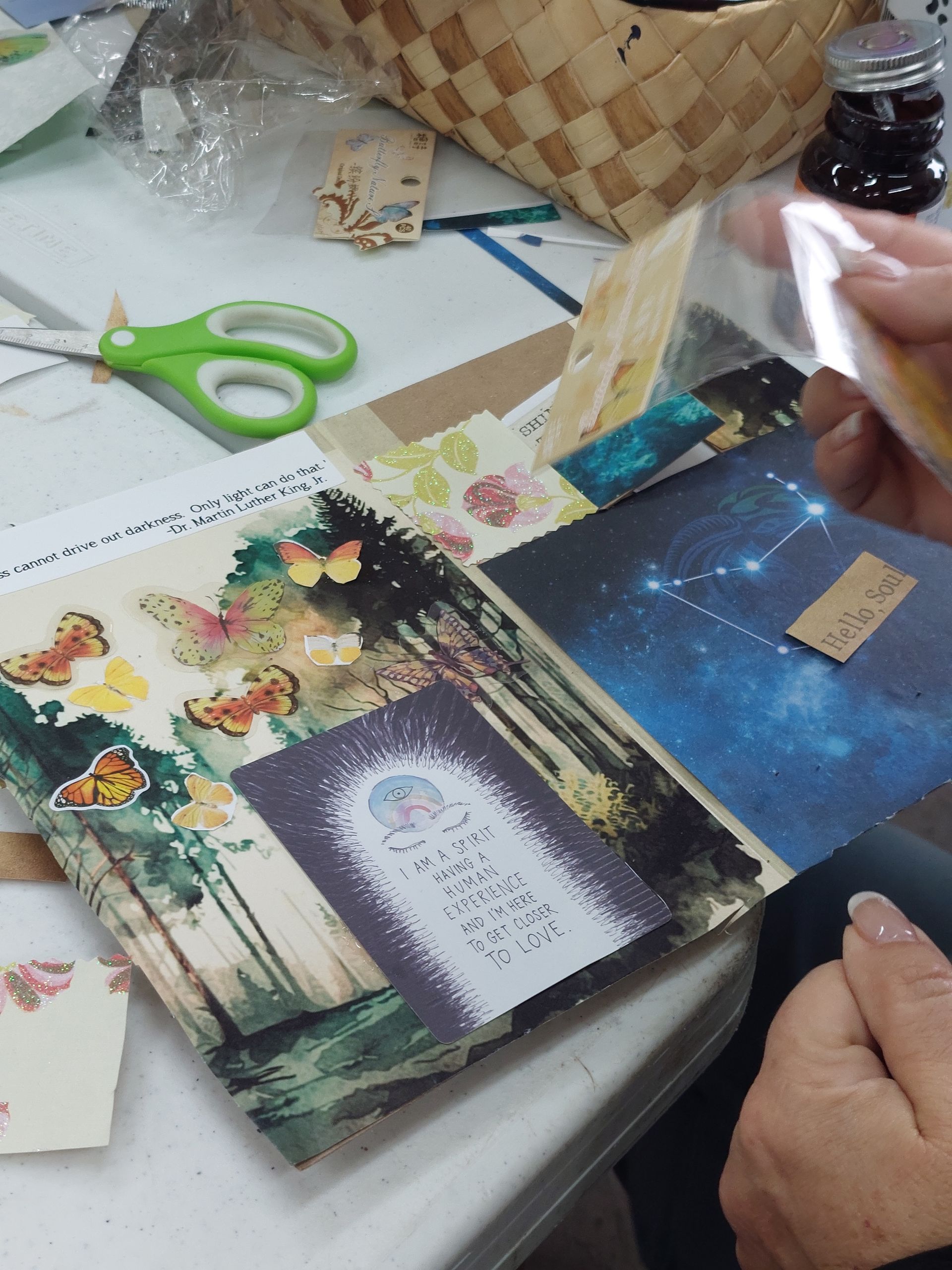 A person is holding a piece of paper with a sticker on it that says 