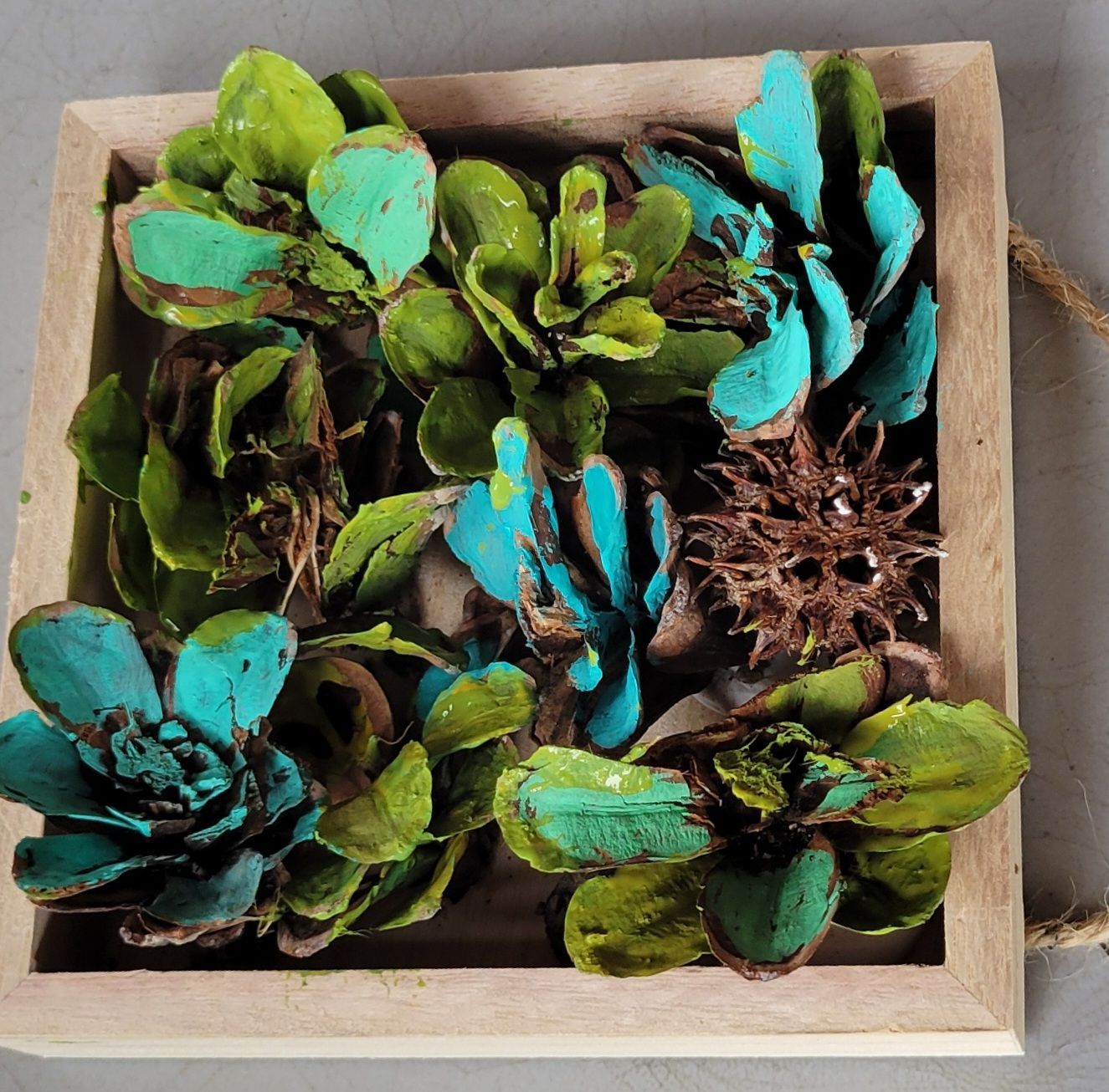 A wooden box filled with green and blue flowers