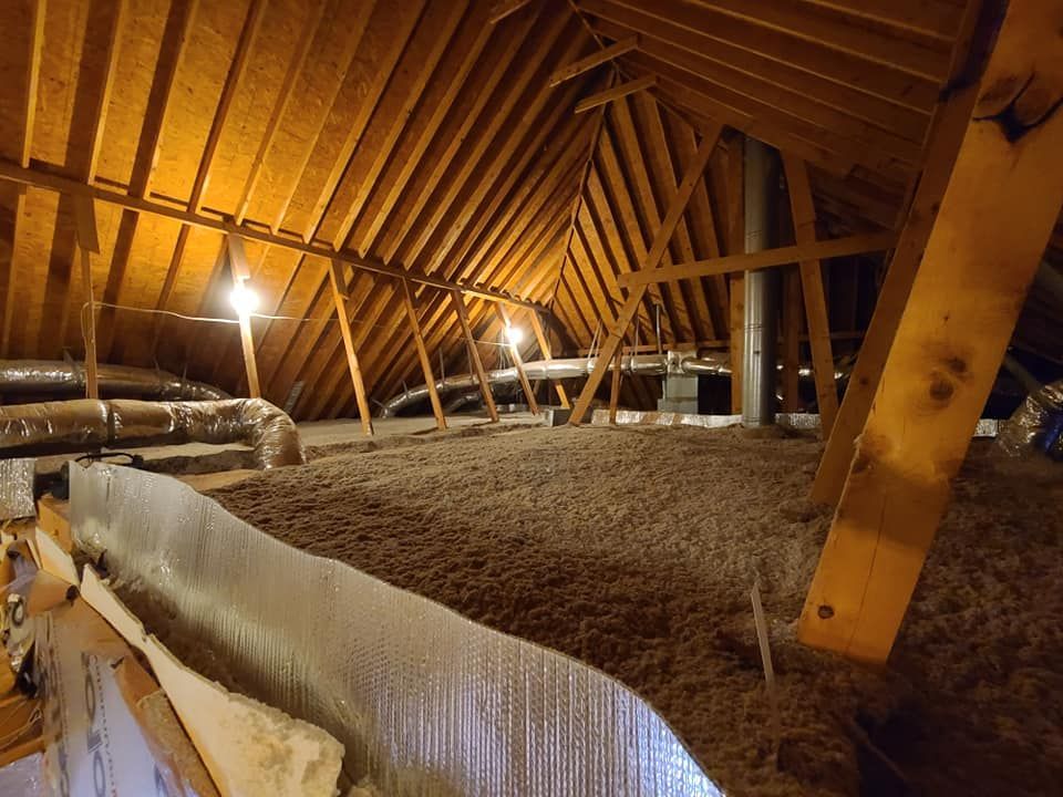There is a lot of insulation in the attic of a house.