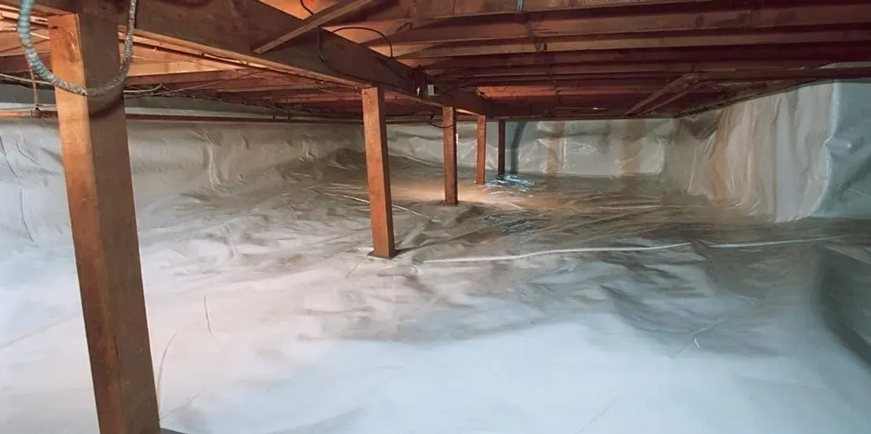 A basement with a lot of insulation and wooden beams.