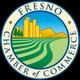 The logo for the fresno chamber of commerce shows a field with a city in the background.
