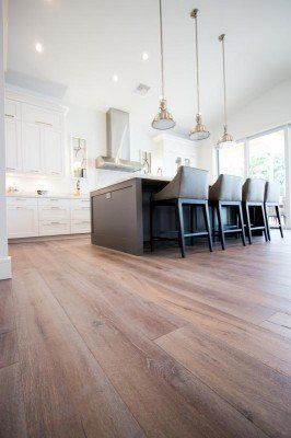 Luxury Flooring Products —  Home Kitchen With White Walls And Wooden Floor in Naples, FL