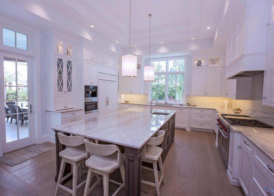 Aged Floors — Modern Style Kitchen Room With White Walls And Quality Rugs in Naples, FL