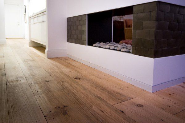 Flooring Needs — Home Living Room With Fire Place And Wooden Flooring in Naples, FL