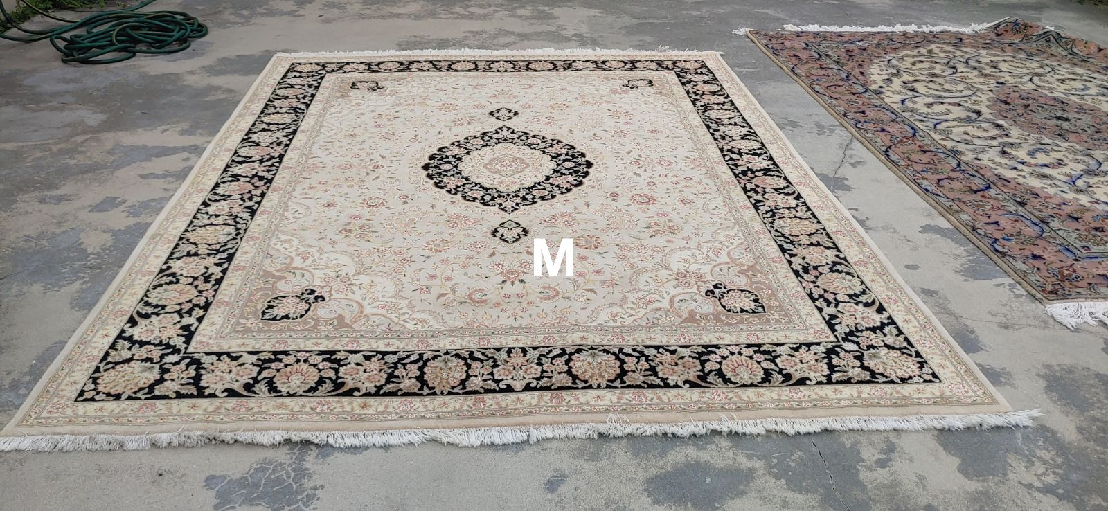 A rug is sitting on top of a concrete floor.
