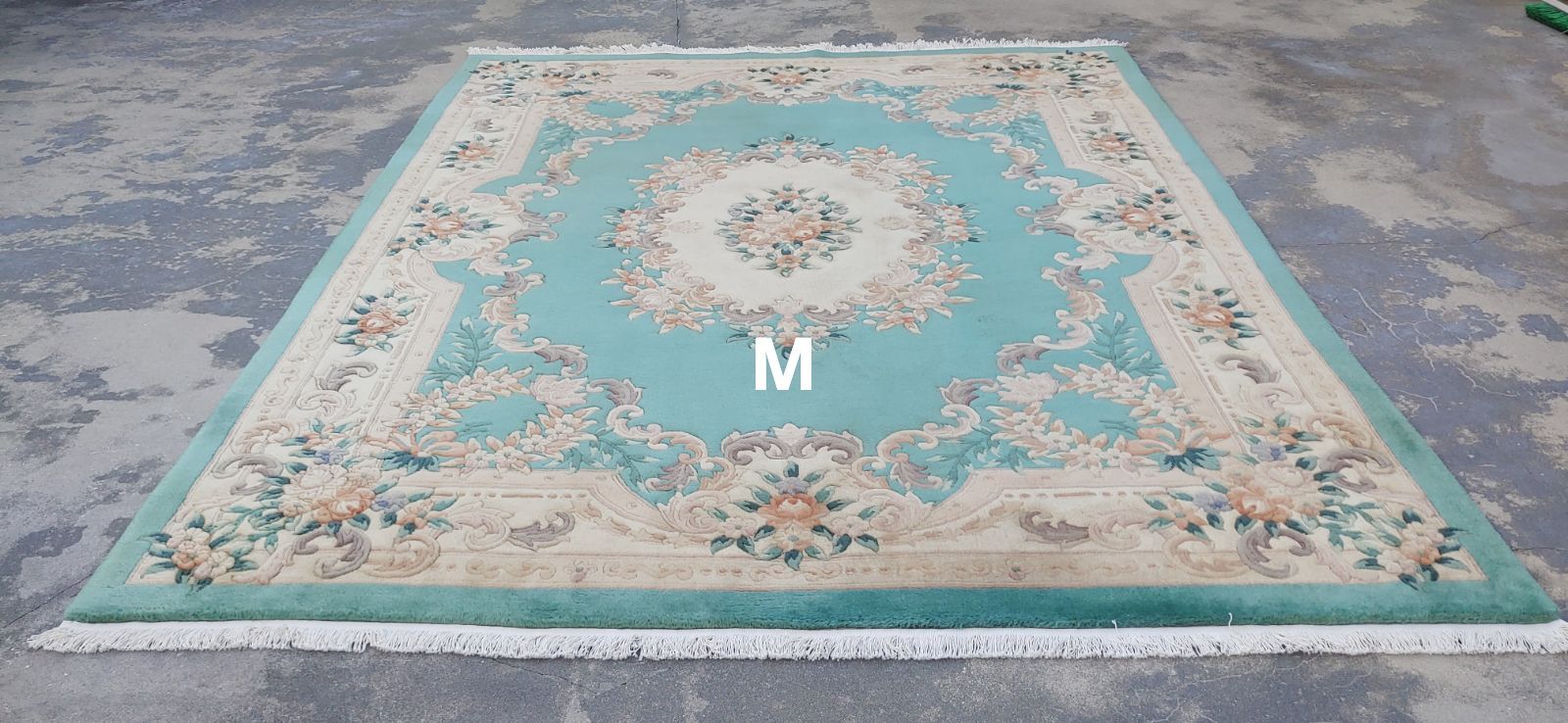 A red rug with the letter m on it