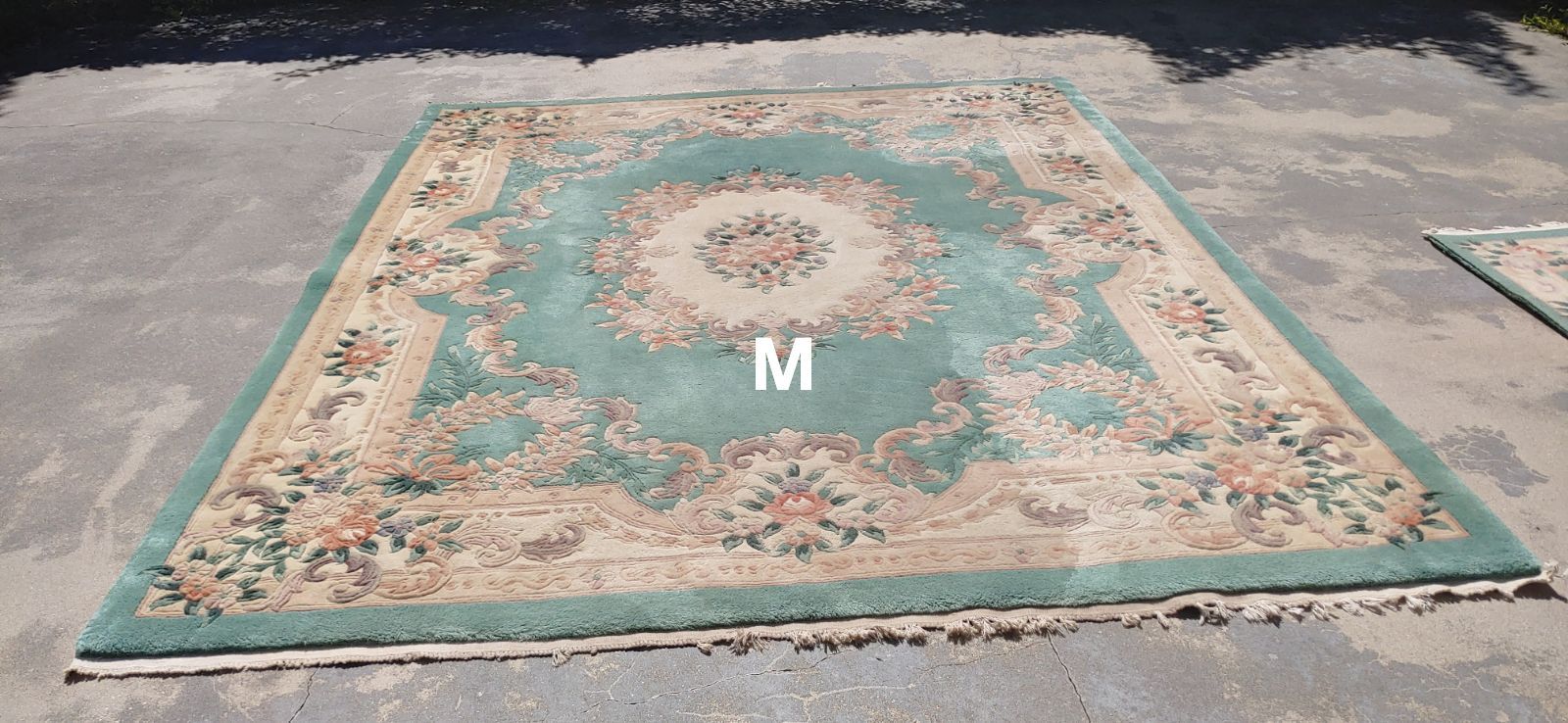 A red rug with the letter m on it
