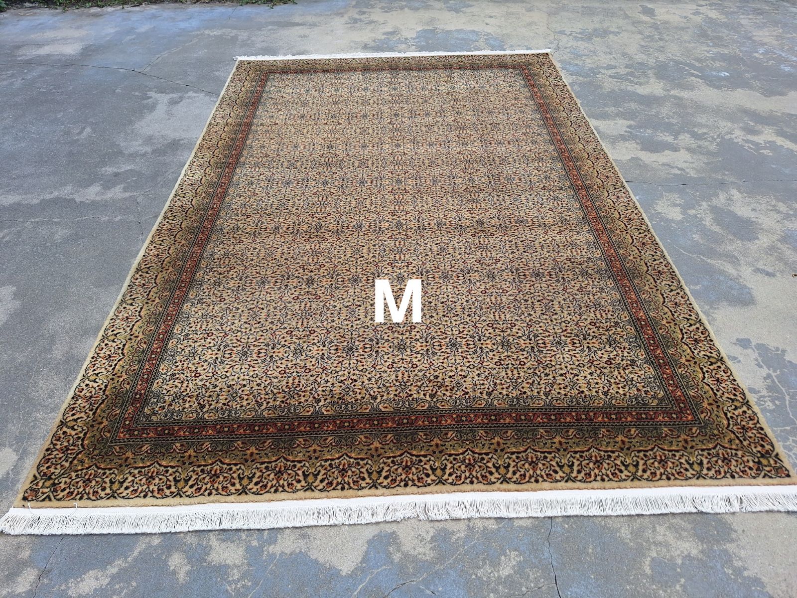 A rug with the letter m on it