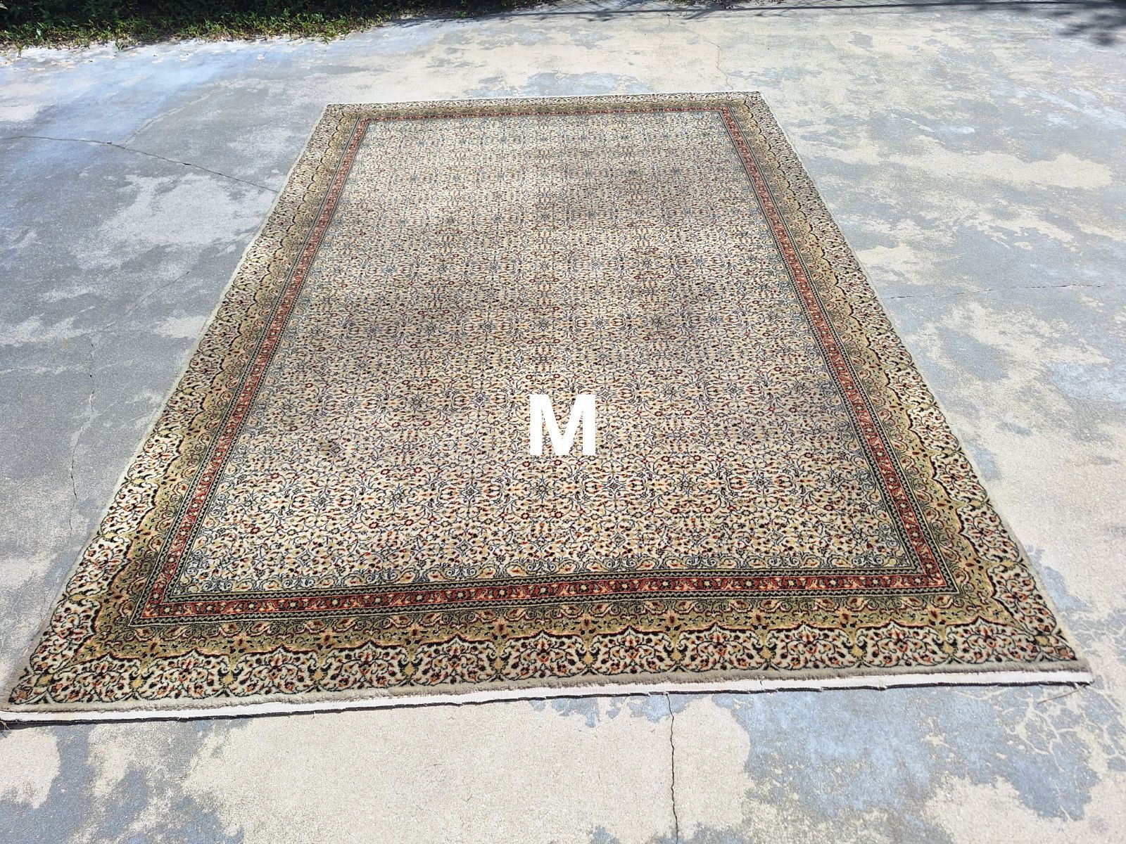 A rug with the letter m on it