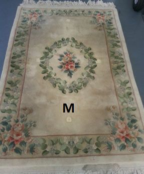 A rug with the letter m on it