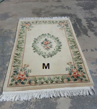 A rug with the letter m on it