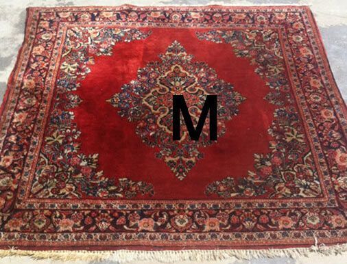 A red rug with the letter m on it