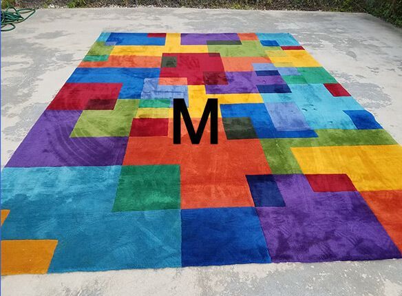 A colorful rug with the letter m on it