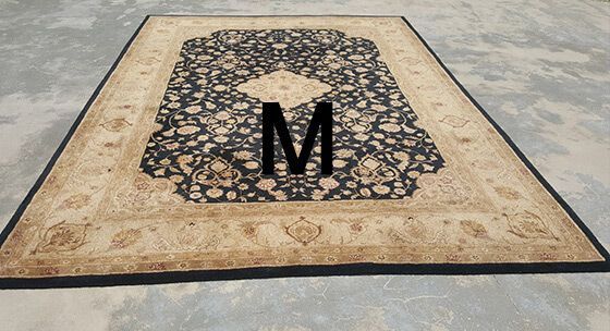 A rug with the letter m on it