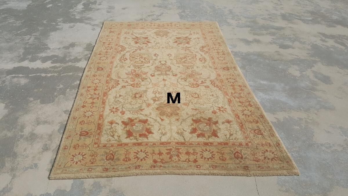 A rug is sitting on top of a concrete floor.