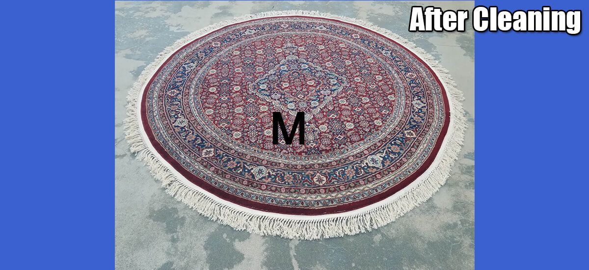 A round rug with the letter m on it