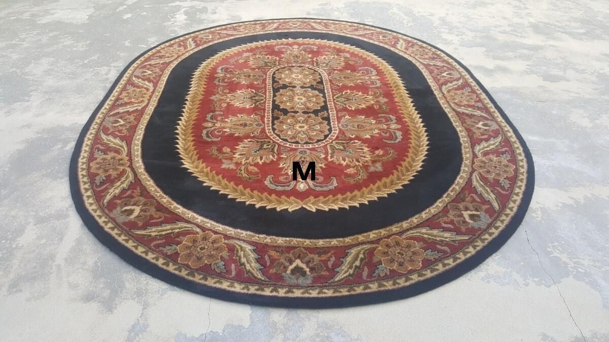 A round rug with the letter m on it