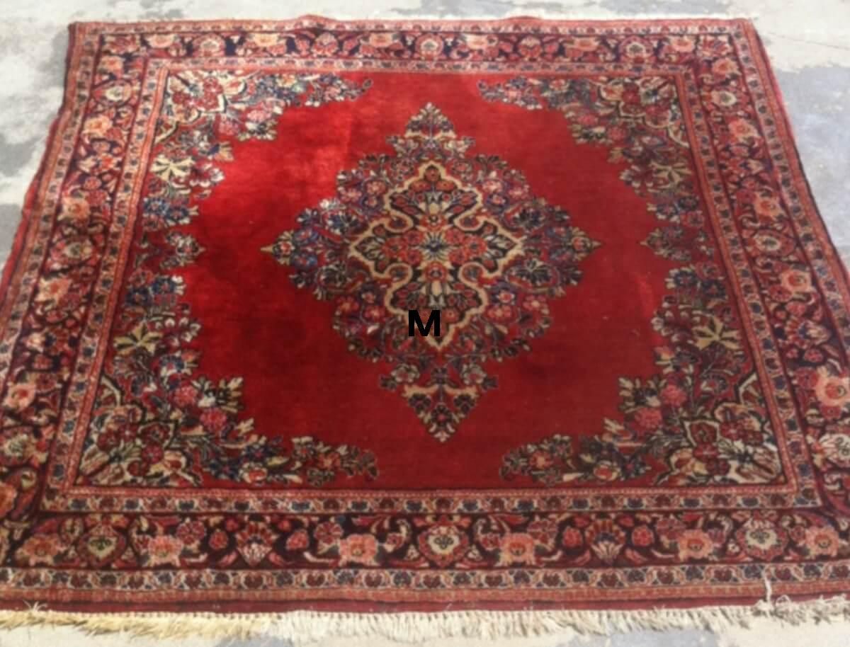 A red rug with a floral pattern is sitting on the ground.