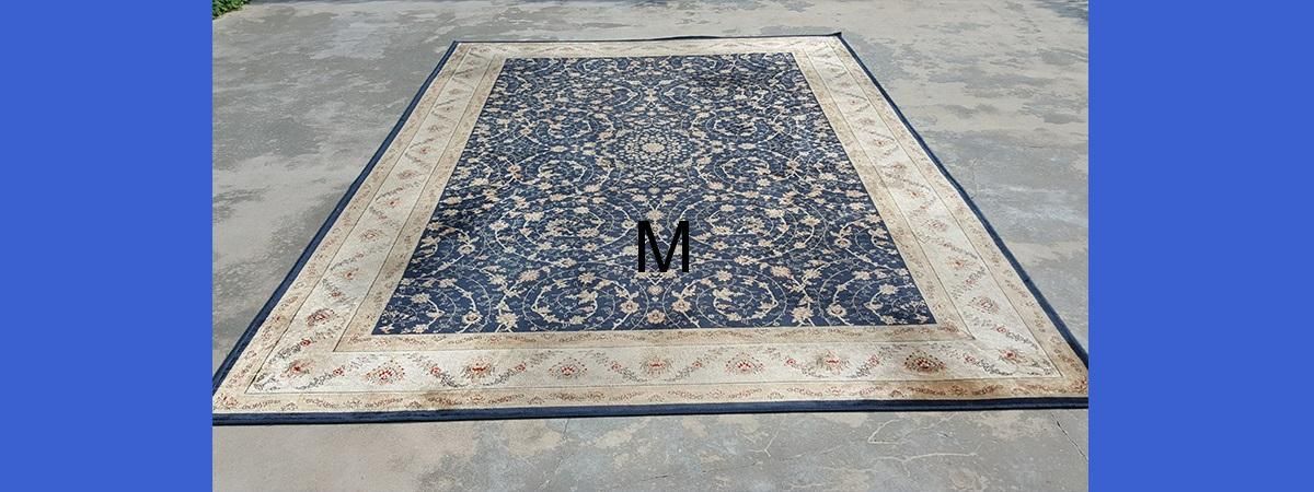 A rug is sitting on top of a concrete floor.
