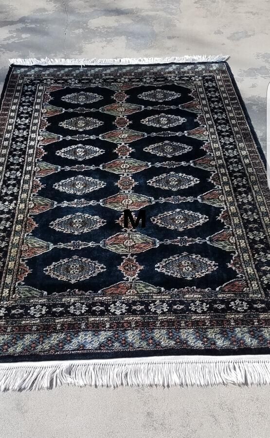 A rug with a pattern on it is sitting on a table.