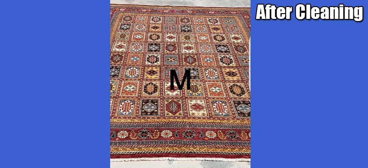 A rug with the letter m on it is being cleaned